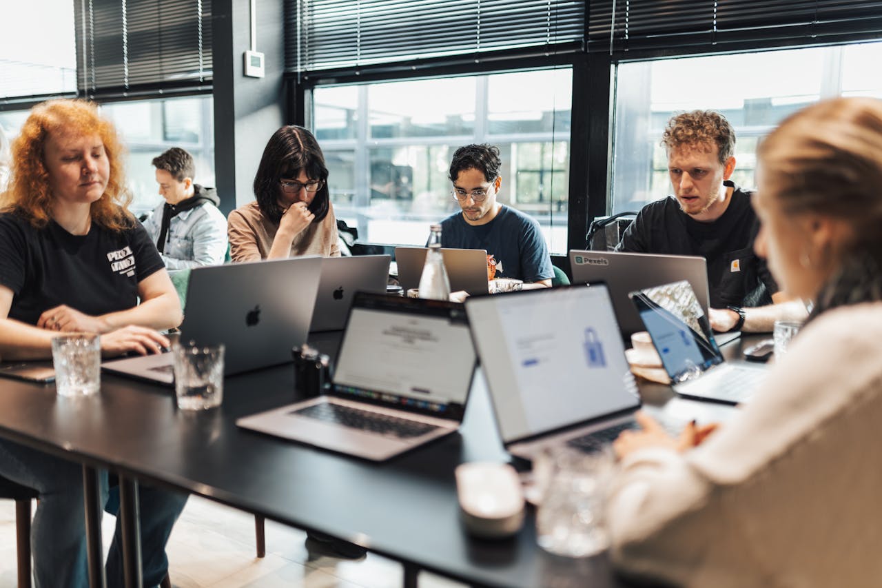 Home Focused team engaged in discussion and planning at a modern office setting.